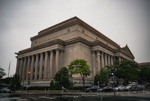 A classic architectural building in Washington D.C. during a cloudy day.