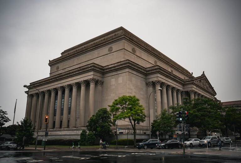 A classic architectural building in Washington D.C. during a cloudy day.